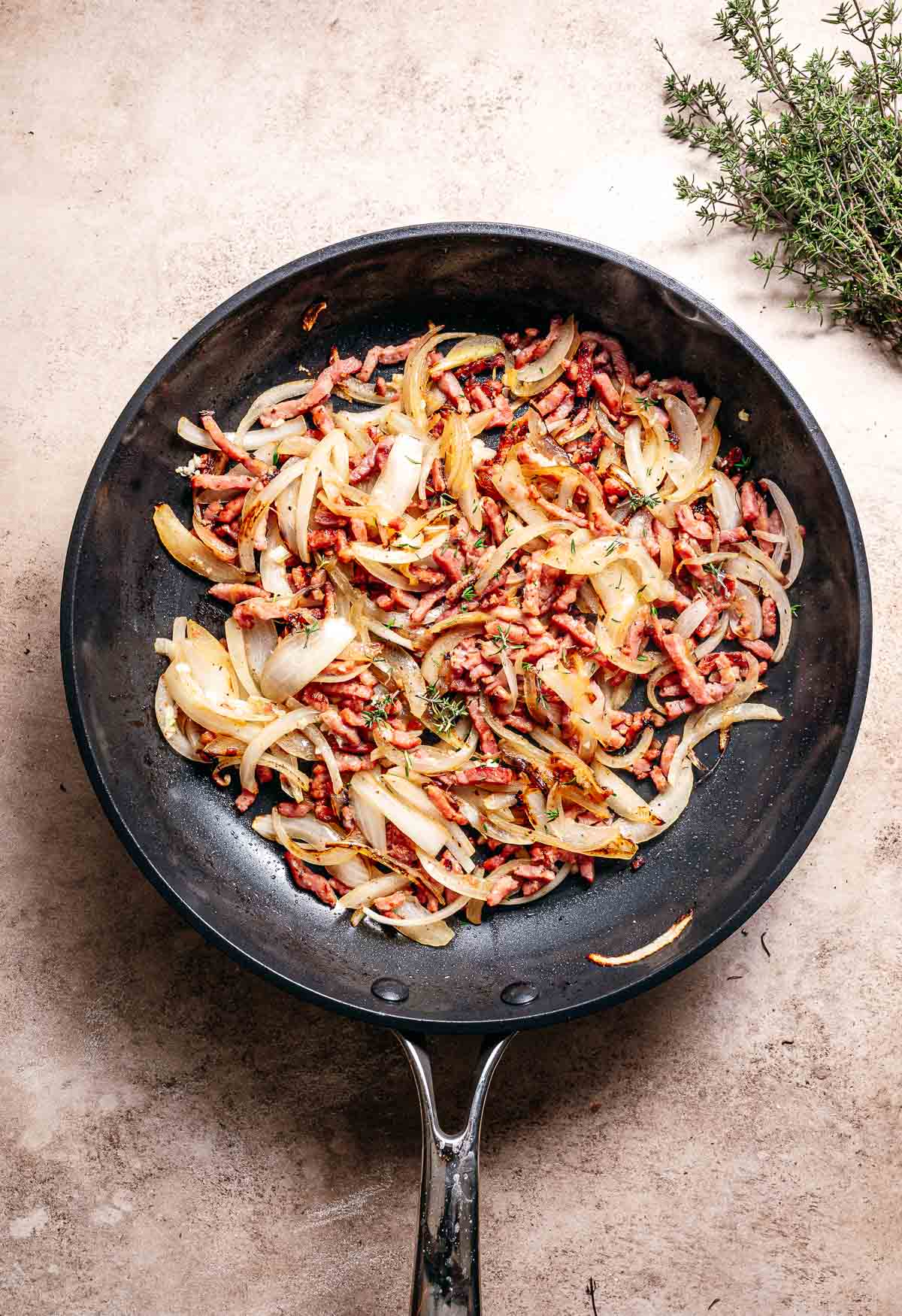Add wine to onions and bacon